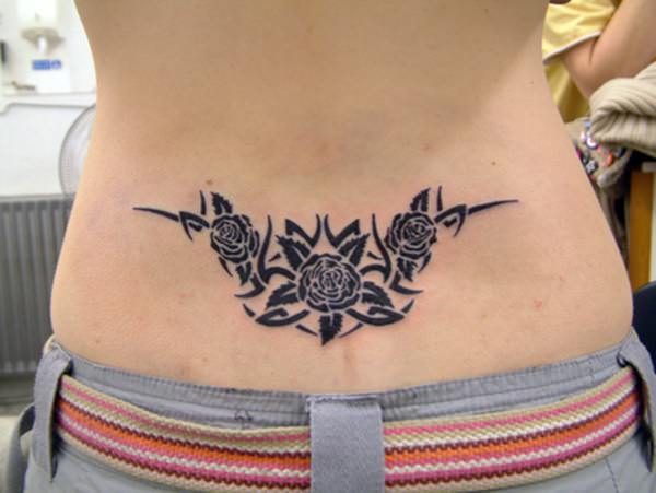 Stylized roses patterns lower back tattoo