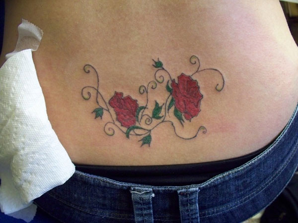 Flowers of wisdom lower back tattoo