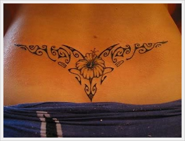 Artistic single flower cutting tattoo design on lower back