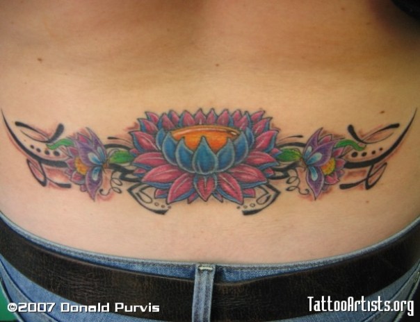 Tribal lotus flower lower back tattoo