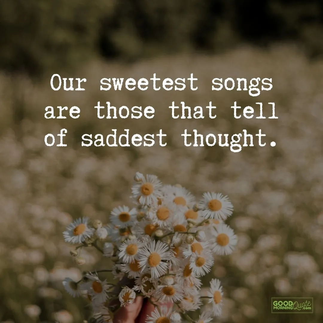 our sweetest songs sad quote with white flowers in the background