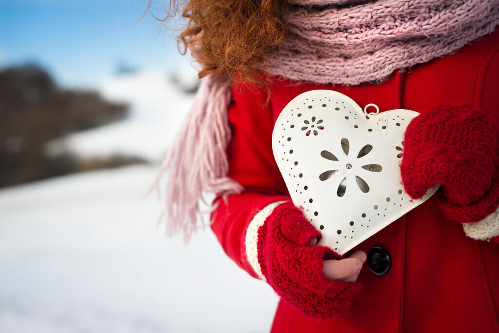 novia sosteniendo un bolso en forma de corazón en invierno